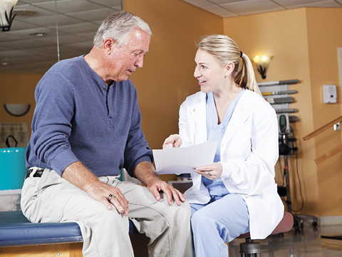 clinician helping elderly man