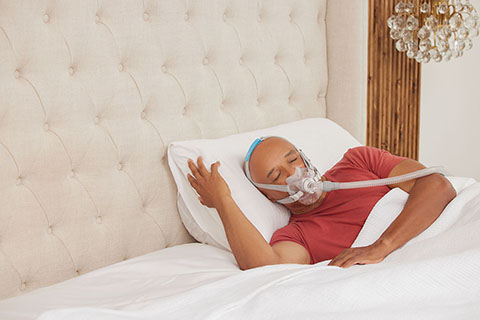 Sleep Apnea BlackMaleOlderPatient WearingResMed AirFitF30PAPmask Sleeping