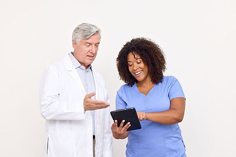 clinical employees looking at tablet together